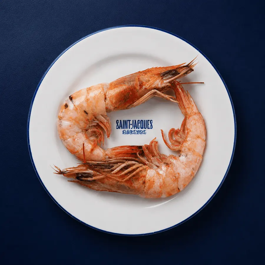 Camarones sobre plato de Saint-Jacques, fondo azul