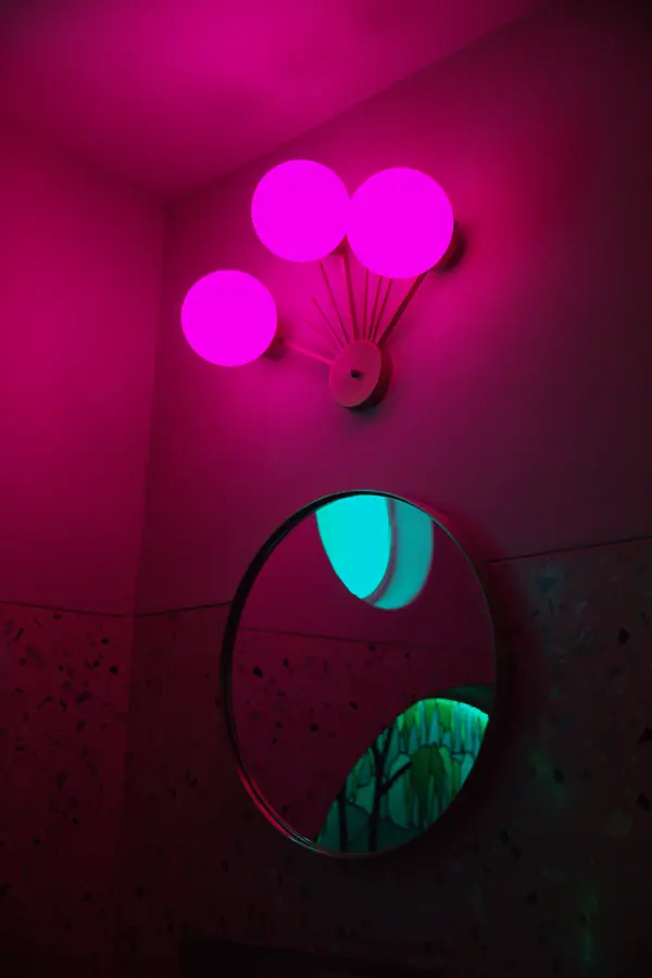 Espejo y luces de neón rosa y turquesa